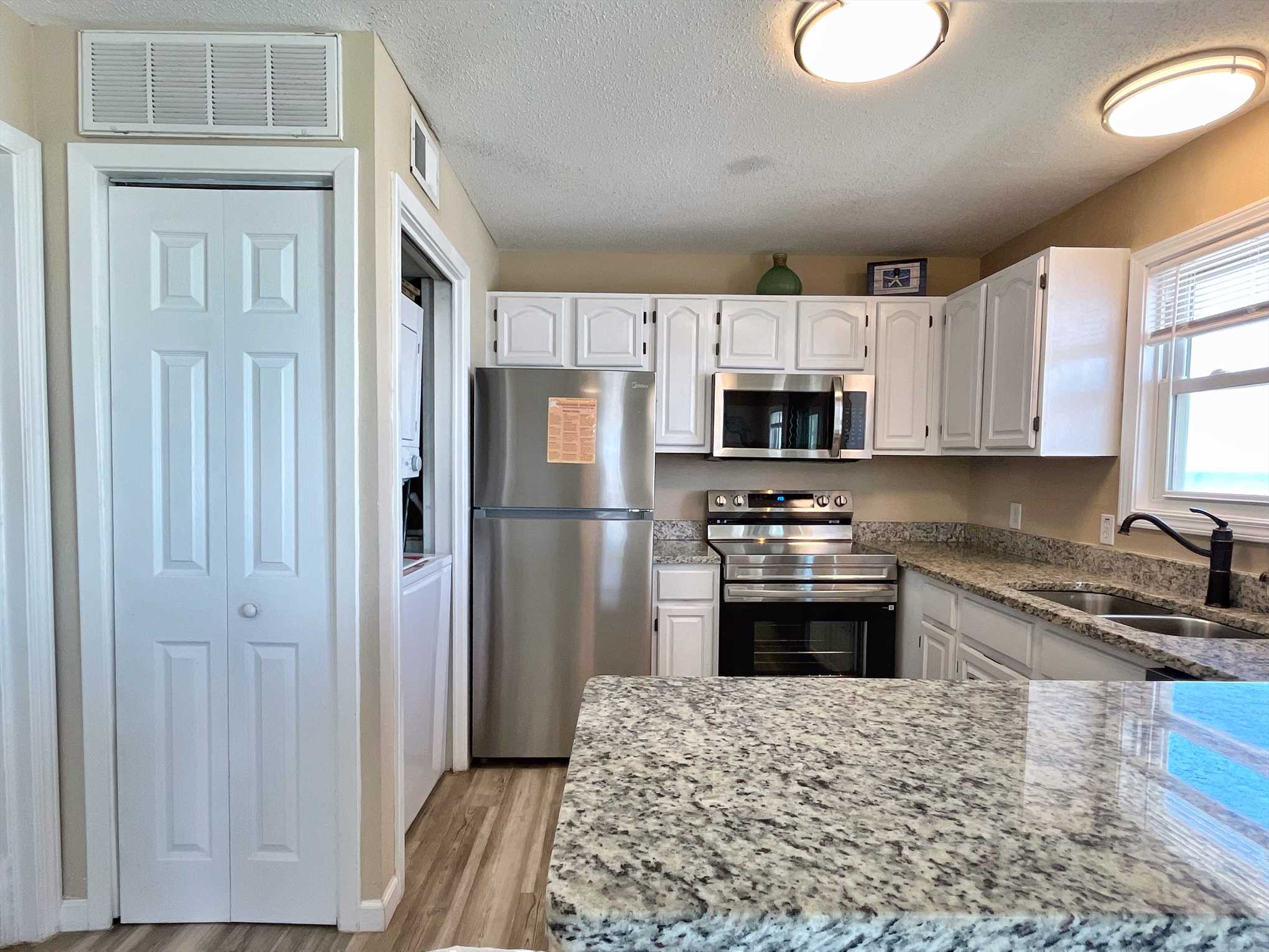 The kitchen includes granite counters - the perfect spot for