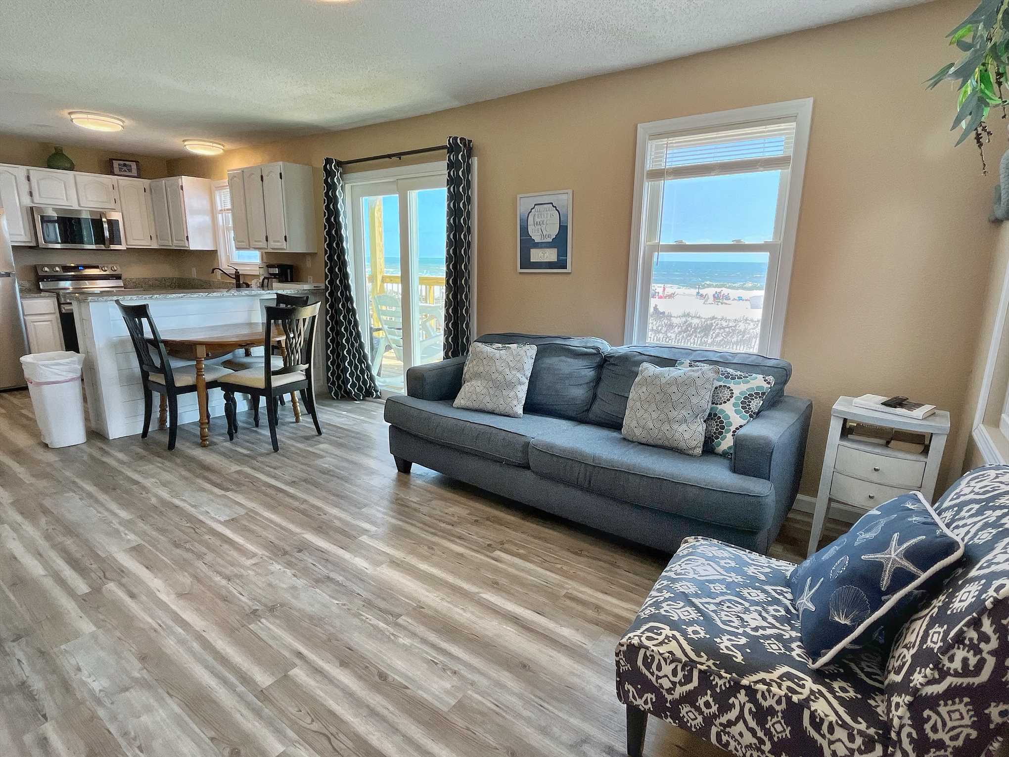 The living / dining area is open with direct access to the p