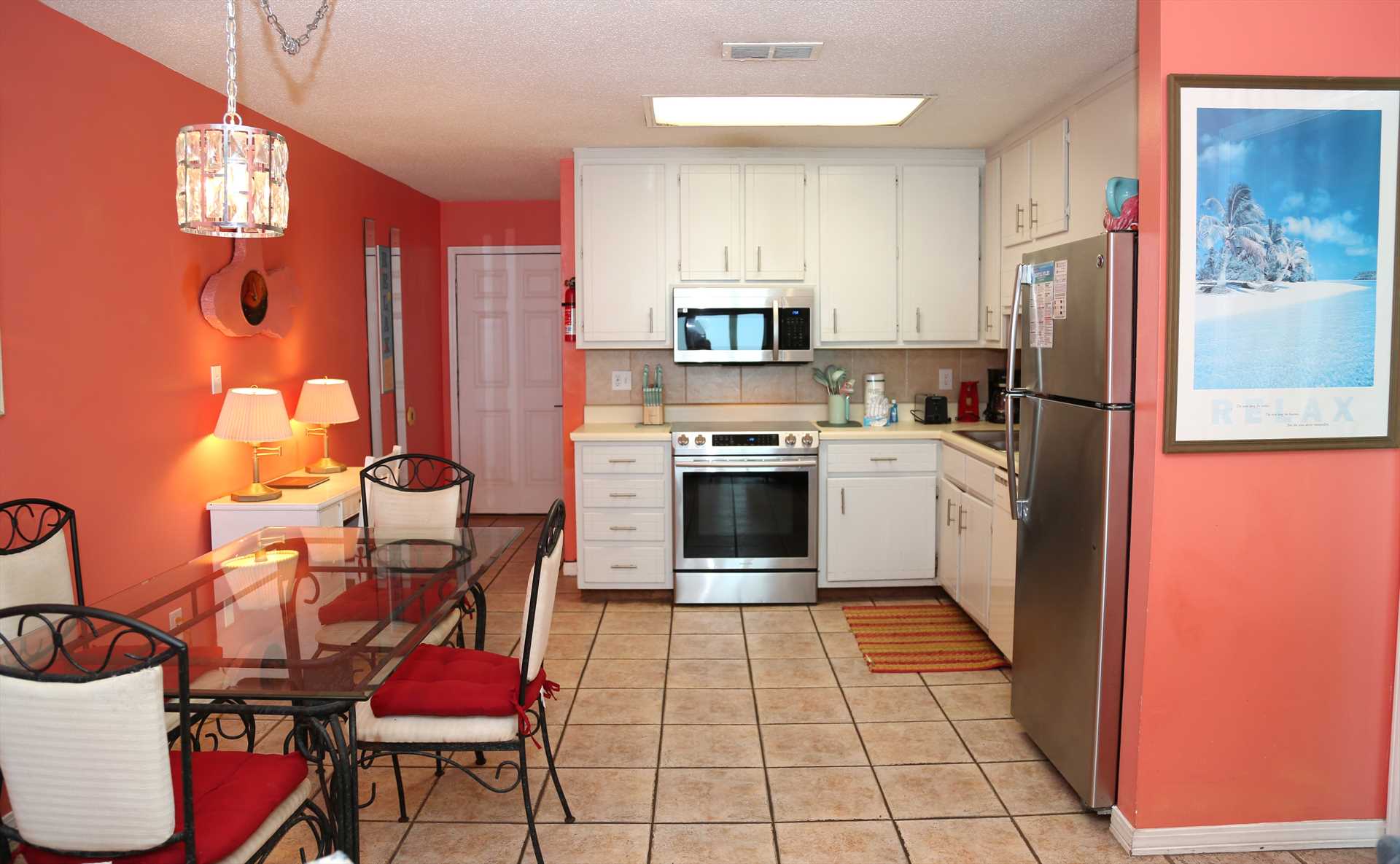 The fully equipped kitchen is stocked with essentials for co