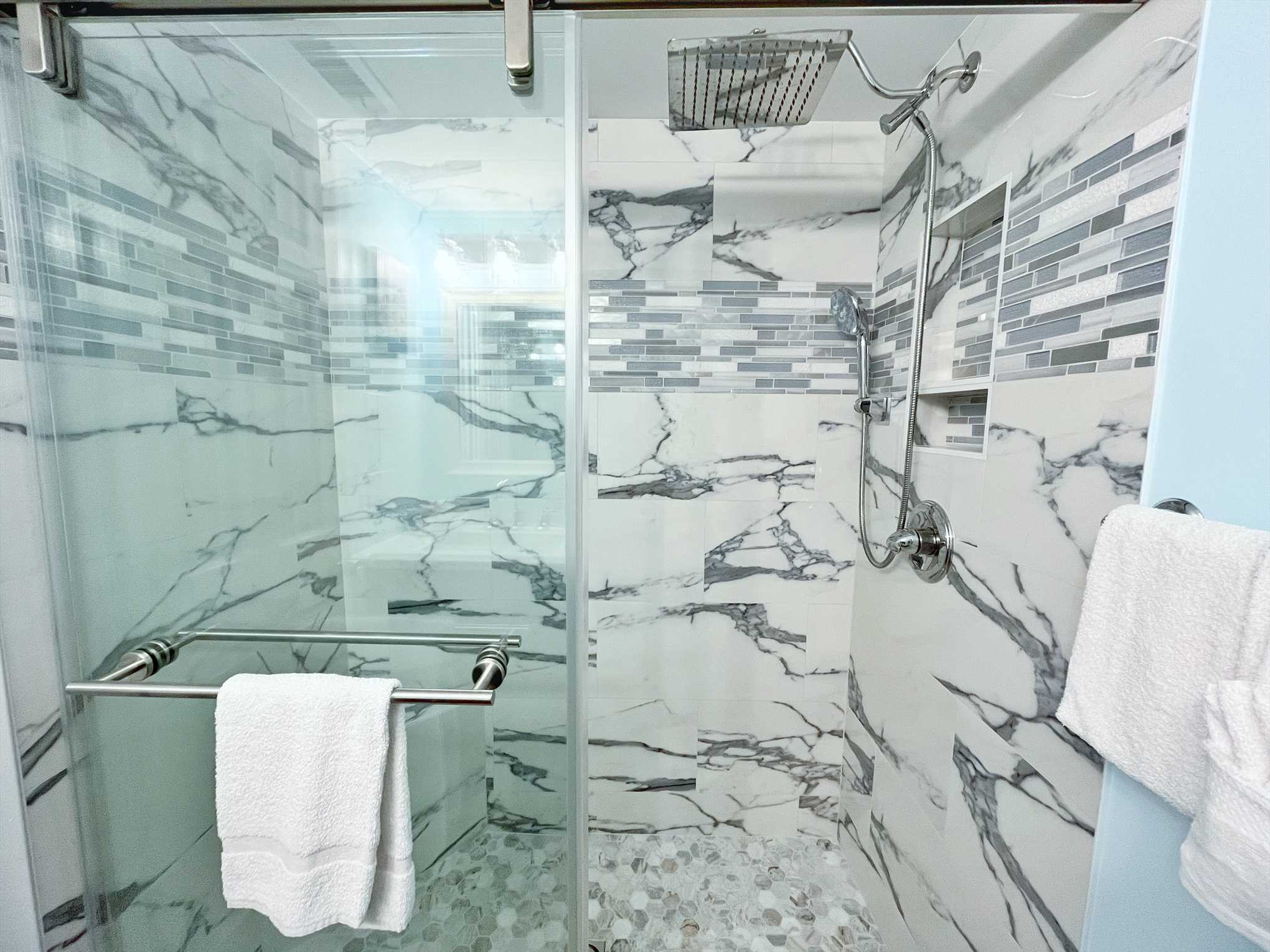 Newly remodeled bathroom with a beautifully tiled shower.