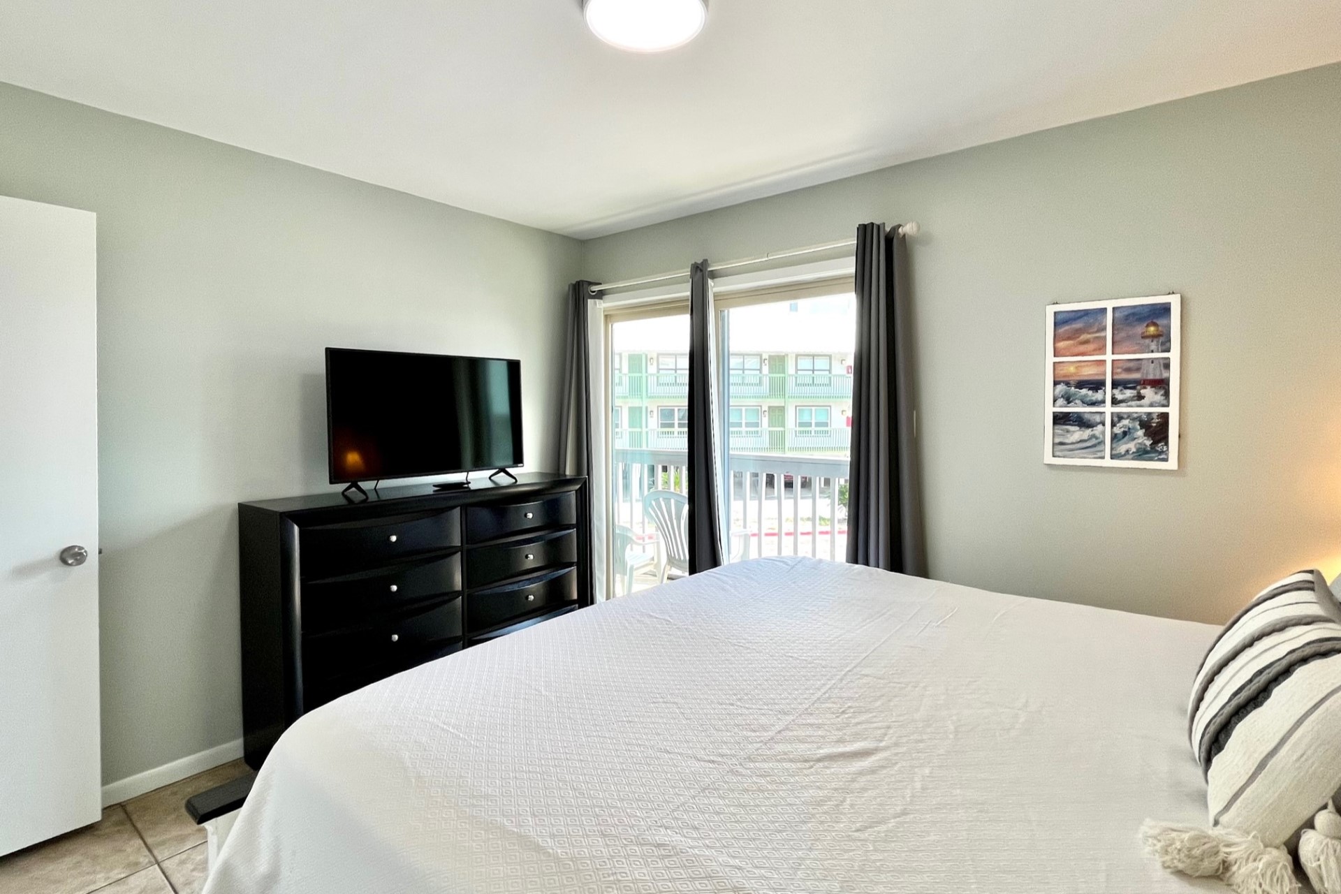 The master bedroom is outfitted with a king-size bed, 32