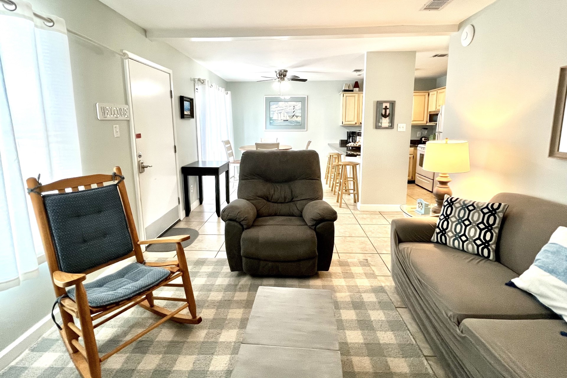 Cozy living area with new sleeper sofa and two side chairs.