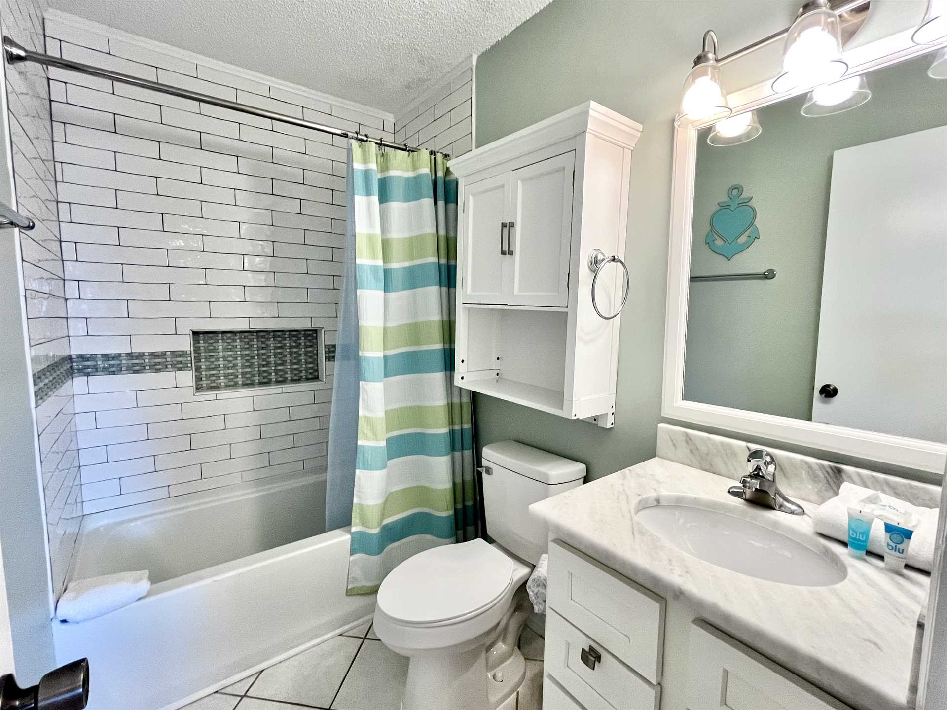 The ensuite bathroom with a beautifully tiled tub surround.