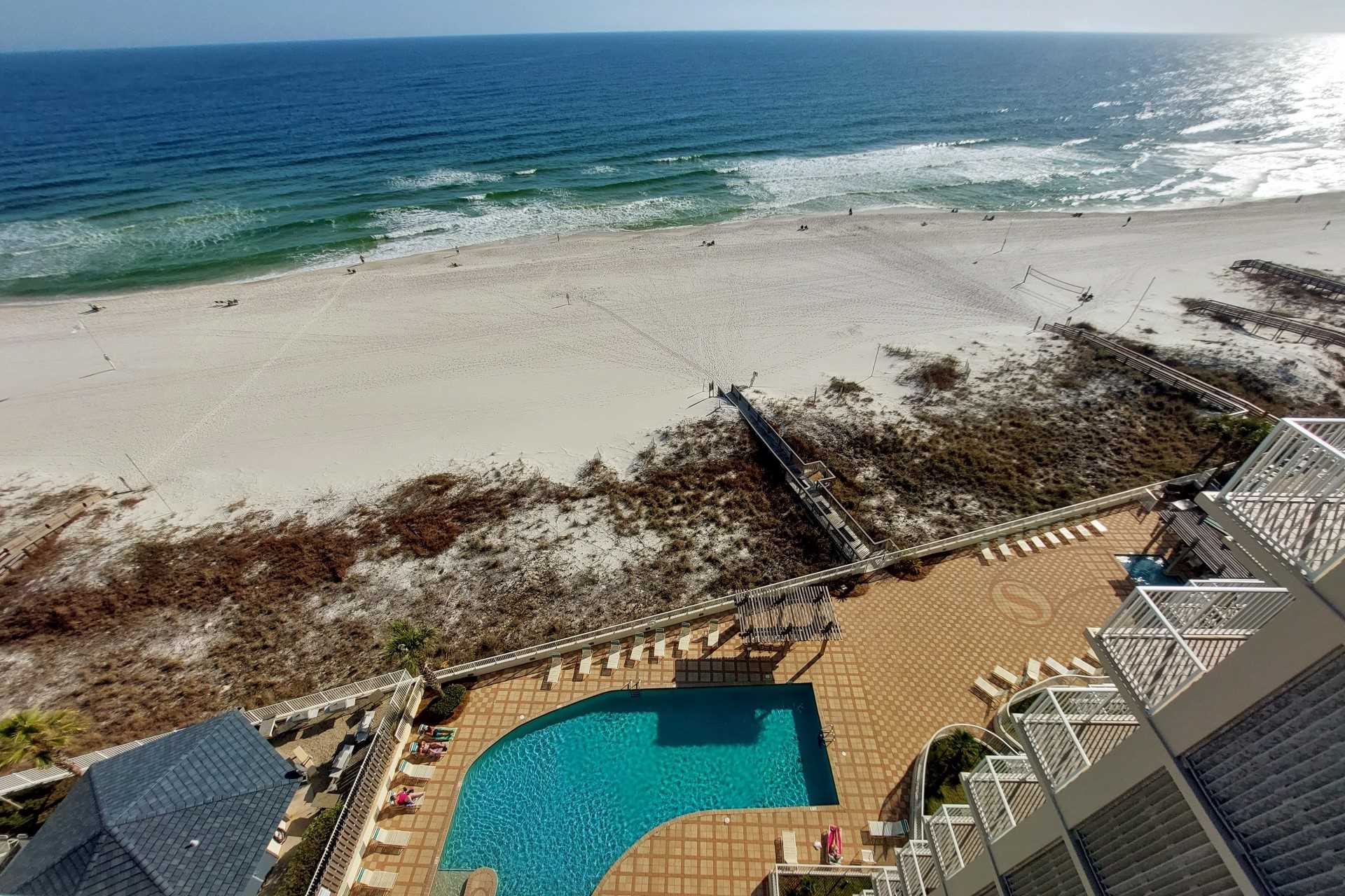 A view from the balcony of the unit Shoalwater 1102 located in Gulf Shores. The view is overlooking the pool and has beachfront views